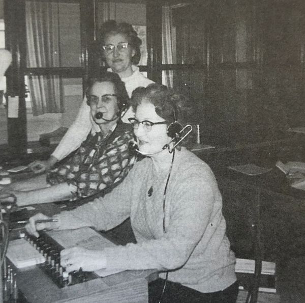 three of Miami's telephone operators siting at there desk. Their names are MArrion Steveson, Marjori