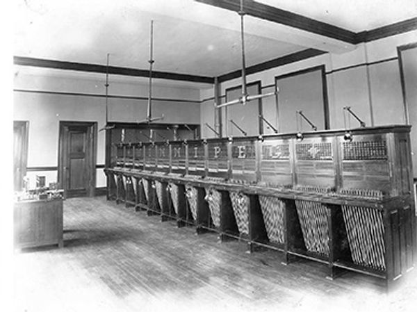 A bank of switchboards sits empty.