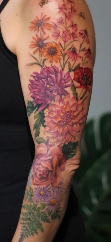 A gorgeous sleeve tattoo with colour realism dahlias and other flowers