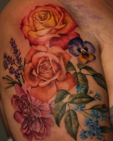 Lovely orange roses and flower tattoo in colour realism