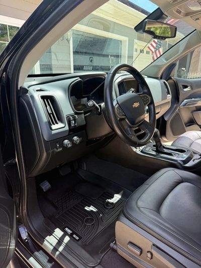 Clean and modern Chevrolet car interior with leather seats and Husky floor mats.