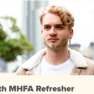 Young man with curly blonde hair outdoors.