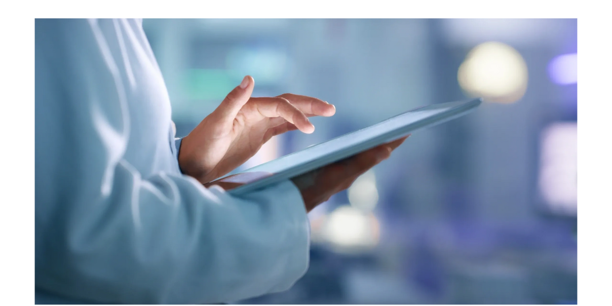 Person using a tablet with a blurred background.