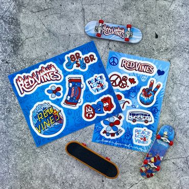 RedVines-themed fingerboards and stickers on concrete.