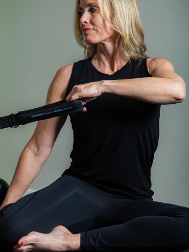 Instructor pulling the black band with hand