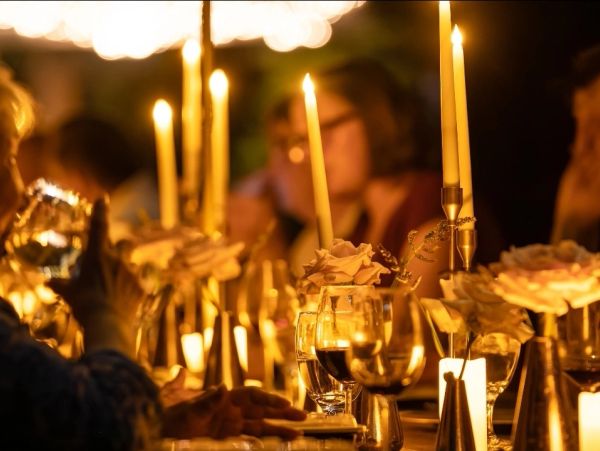 Elegant dinner table with candles and flowers.