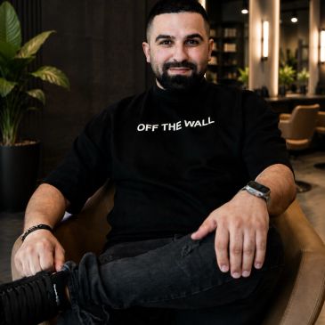 Man sitting comfortably in a modern room.