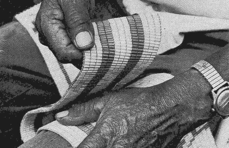 The late Chief Jake Thomas' hands with a Wampum belt.