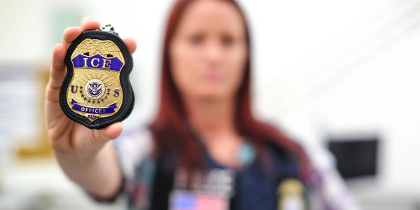 Person holding an ICE badge.