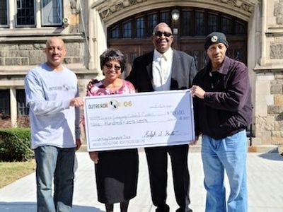 people holding giant check