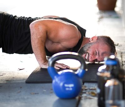 A boot camp member having so much fun at Trainer Nate's class that he cannot help but smile. 