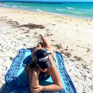 Young women on the beach with a Sovicious hat on 
lifestyle brand fitness and lifestyle clothing