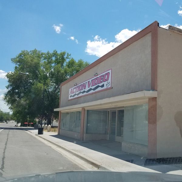 Empty video store called Action Video on a sunny day.