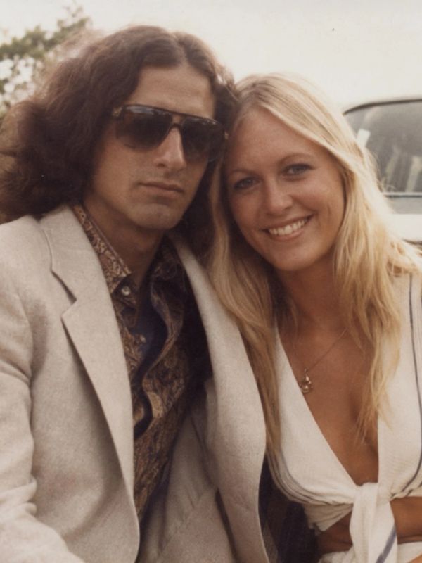 Young couple posing for a photo outdoors.