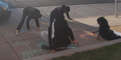 Youth executing an EcoVoice project with street chalk.