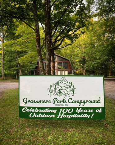 Banner celebrating 100 years of outdoor hospitality at Grassmere Park, for the Hess family