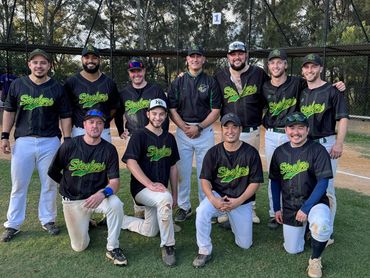Baseball team posing on field, wearing black jerseys with "Stealers" logo.