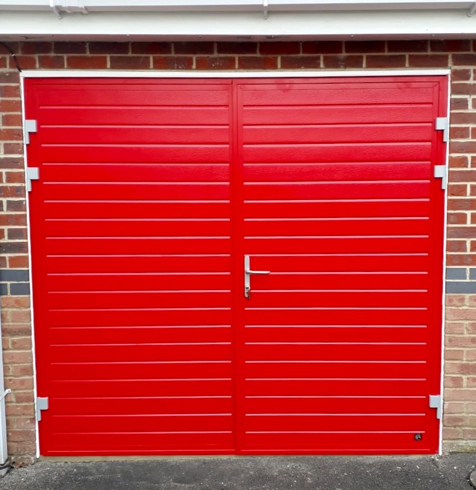 Insulated side-hinged garage door in Red