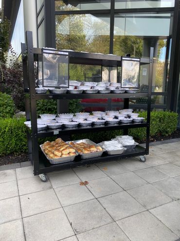 Mission Belly Full meals on cart for donation.