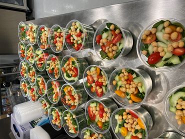 Mission Belly Full meals being prepared for donation. Healthy salad.