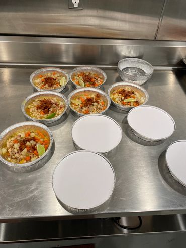 Mission Belly Full meals being prepared for donation.