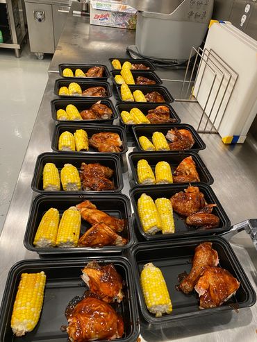 Mission Belly Full meals being prepared for donation. Chicken and corn.