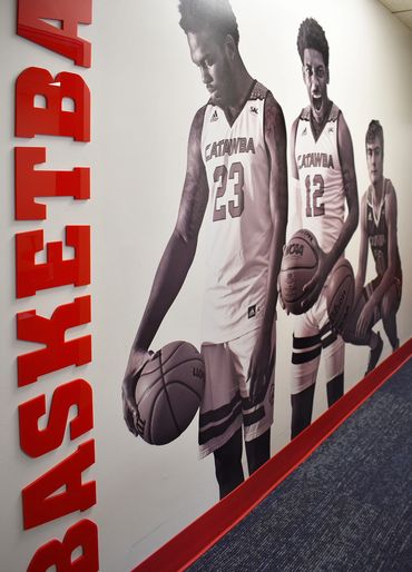 Basketball lettering and photos of key team players