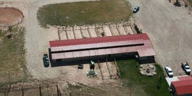 Aerial shot of barn with paddocks