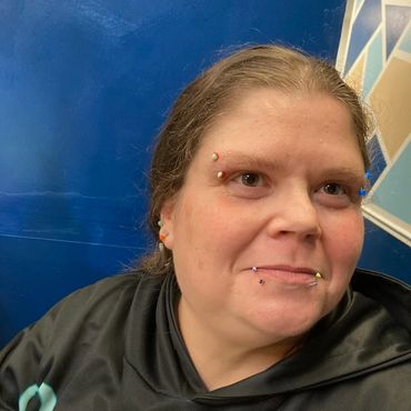 lady eyebrow and lip piercing at indigo tattoos shop