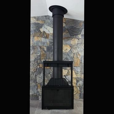 Sculpt freestanding wood fireplace install with stone rear wall installation on the Sunshine Coast.