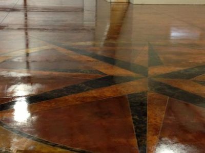 Acid stained concrete floor with a 50 ft. compass scored into the slab stained in 4 different colors