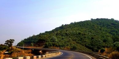 a highway beside a hill