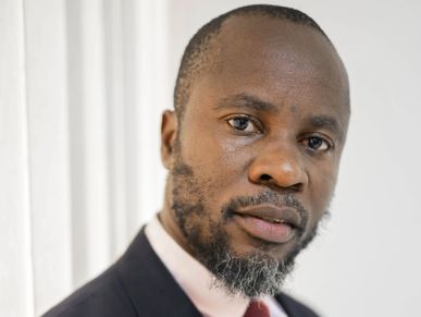 a man in a suit with a red tie