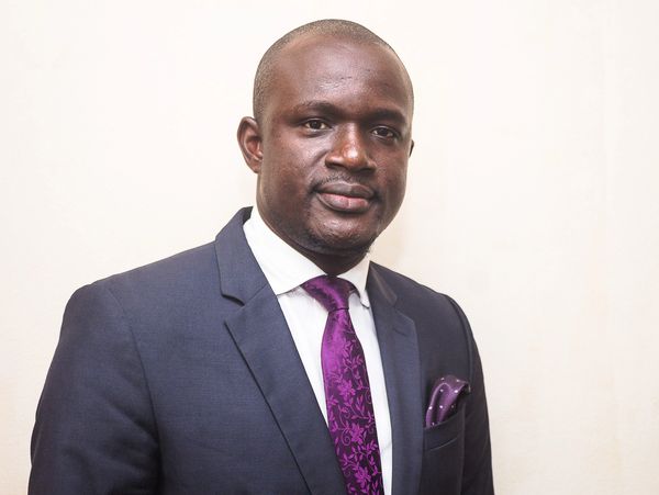 a man in a suit with a purple tie