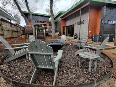Clean and modern hardscape design featuring durable metal edging and decorative gravel for firepit