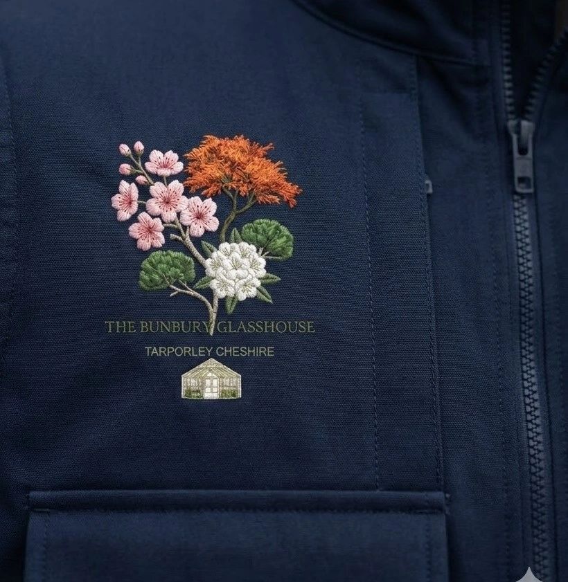 Navy jacket with floral embroidery and text from The Bunbury Glasshouse, Tarporley Cheshire.