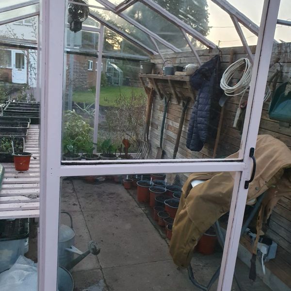 Propagation greenhouse with gardening supplies and plants.