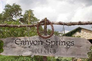 Wooden sign for Canyon Springs Golf Club.