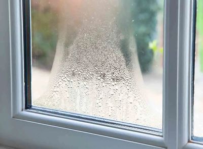 Condensation forming a water droplet pattern on a window.
