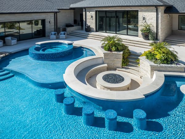 Luxury beachfront hotel with infinity swimming pool at sunset