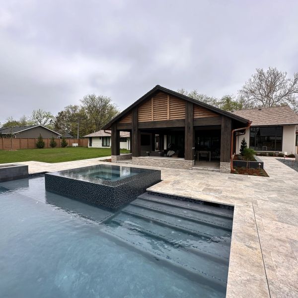 Contractors building custom pools in a backyard in Wichita, KS.