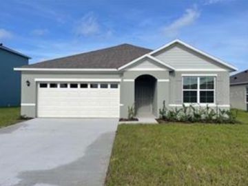 New construction one story grey stucco home with white two car garage and a large front window