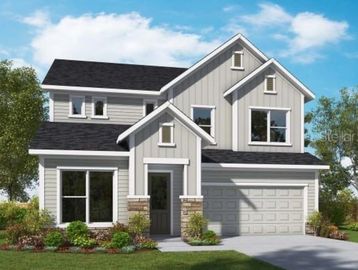 New construction two story grey siding home with white trim, two car garage and shrubs and oak trees.