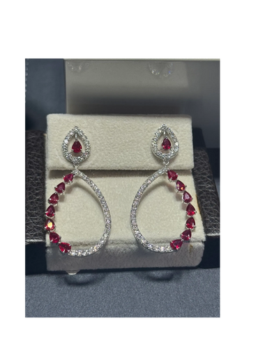Elegant teardrop earrings with red and white gemstones.