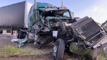 Severe front-end damage to a large semi-truck after a crash.