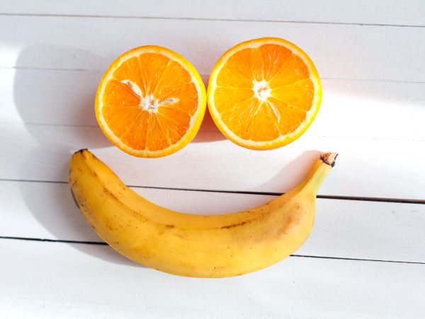 Smile made with orange halves and a banana.