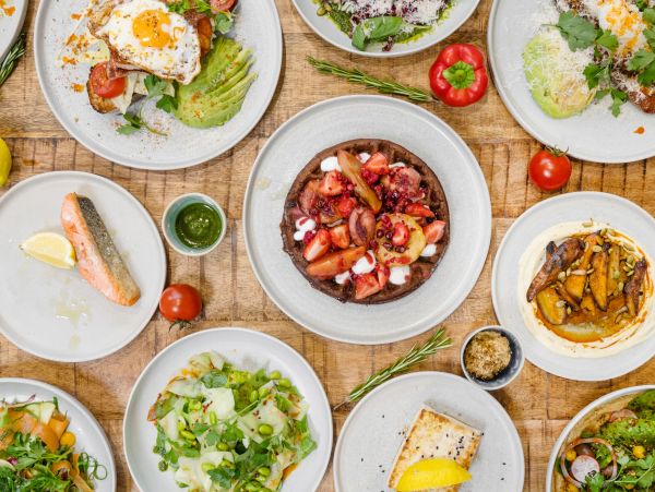 Top view of various dishes on a wooden table.