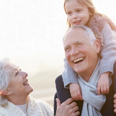 Elderly couple enjoying time with their granddaughter after cataract surgery