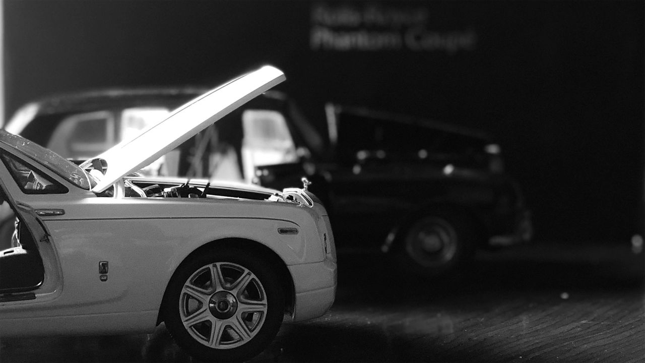 A white car with an open hood A white car with an open hood