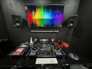 Sleek DJ setup with Pioneer equipment and colorful screen visualization.